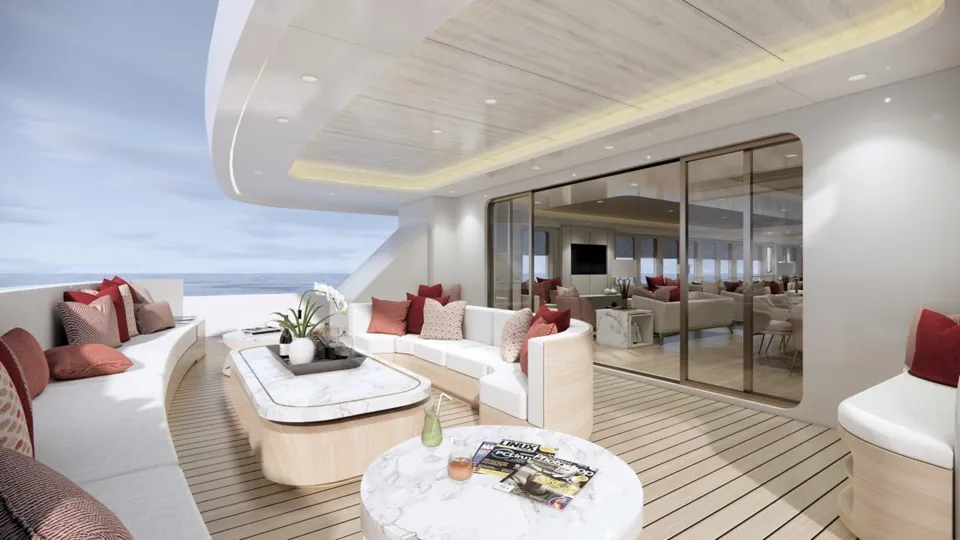 The aft lounge: an outdoor sofa and marble tables, with glass doors to the salon