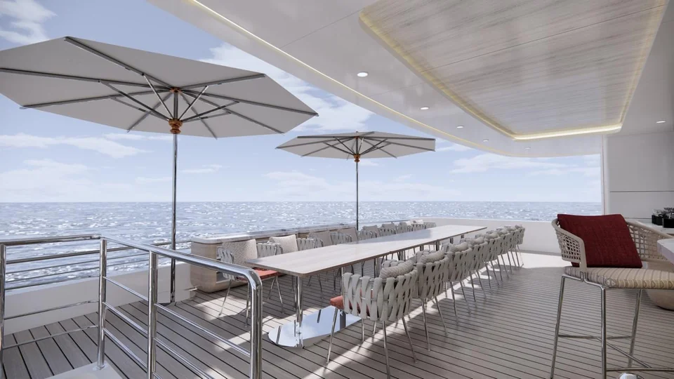 A long outdoor dining table under white parasols