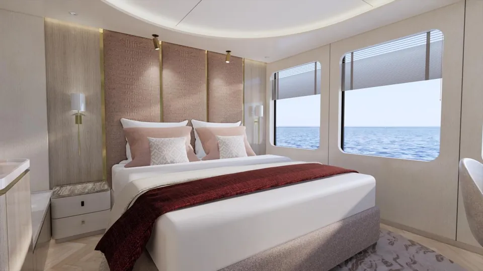A guest cabin: a double bed against an upholstered pink headboard, with two windows to the sea