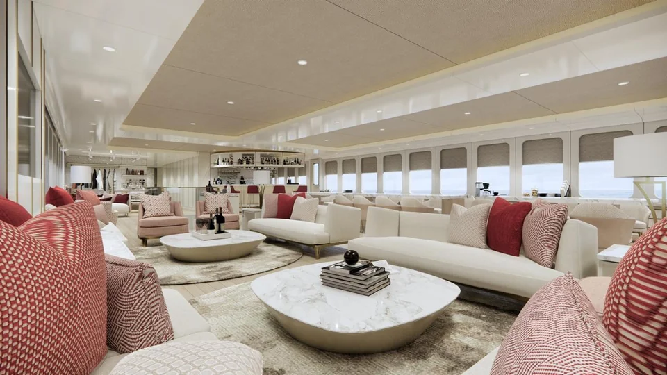 The salon, with cream sofas and burgundy cushions around marble tables