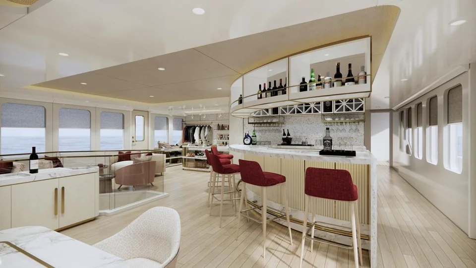 The main-deck bar with burgundy stools and shelves of bottles